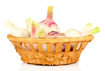 Fresh garlic, in wicker basket isolated on white