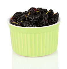 Ripe mulberries in bowl isolated on white