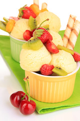 Delicious  ice cream with fruits and berries in bowl close up