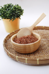 Red rice in wooden bowl