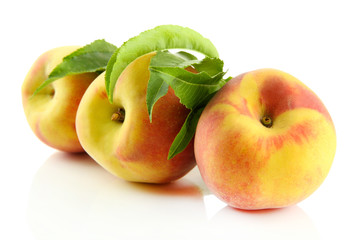 Ripe sweet peaches with leaves, isolated on white