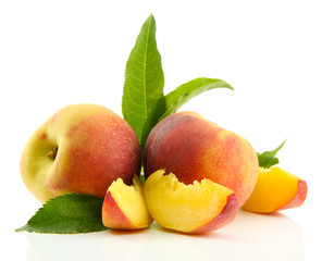 Ripe sweet peaches with leaves, isolated on white