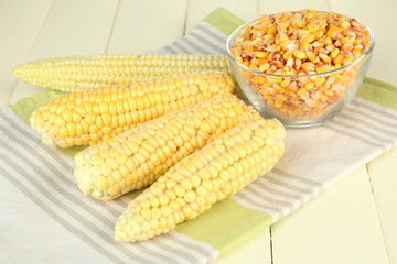 Fresh and dried corn on wooden background