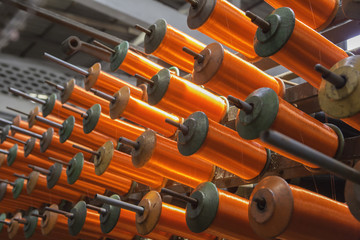 Large group of bobbin thread cones on machine