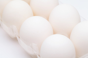 White egg in plastic container