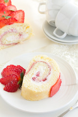 Swiss roll filled with cream and strawberries.