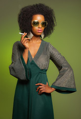 Smoking retro 70s fashion afro woman with green dress and sungla