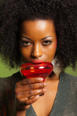 Retro 70s afro fashion woman with green dress and orange cocktai