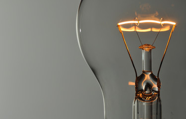 Close up glowing light bulb - obrazy, fototapety, plakaty