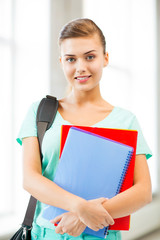 student girl with school bag and notebooks