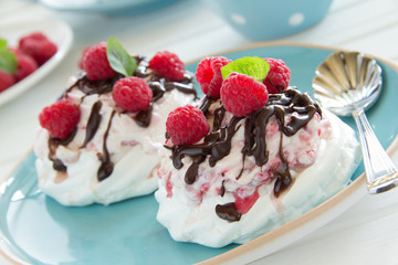 Meringue with raspberry cream, raspberry and chocolate.