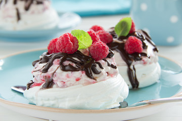Meringue with raspberry cream, raspberry and chocolate.