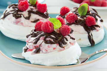 Meringue with raspberry cream, raspberry and chocolate.