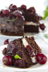 Chocolate cake with cherries and chocolate cream.
