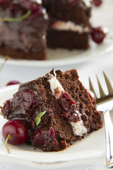 Chocolate cake with cherries and chocolate cream.