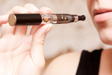 Woman smoking with electronic cigarette