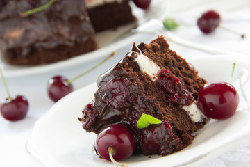 Chocolate cake with cherries and chocolate cream.