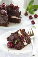 Chocolate cake with cherries and chocolate cream.