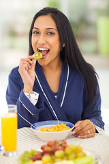 indian woman eating kiwifruit