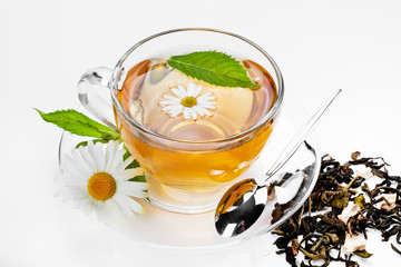 Cup with green tea and green leaves.