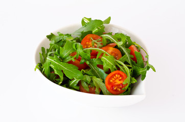 bowl of fresh green, natural arugula and cherry tomatoes