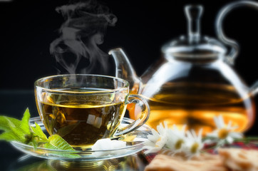 Cup with green tea and green leaves.