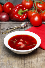 Traditional beetroot soup on old wooden table