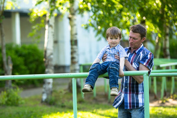 Fototapeta na wymiar Father and son on the playground