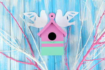 Decorative nesting box with paper birds and color branches,