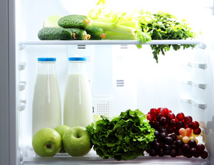 Open refrigerator with vegetarian food