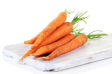 Carrots on cutting board, isolated on white