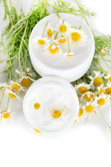 Cream with chamomile isolated on white