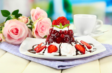 Tasty jelly dessert with fresh berries, on bright background