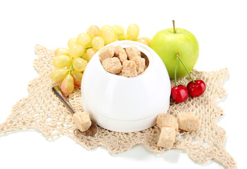 Unrefined sugar in white sugar bowl on grey background