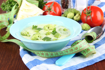 Cabbage soup in plates on napkin on wooden table
