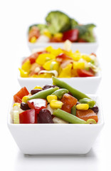 Fresh vegetable salad in white bowl. Spring party table.
