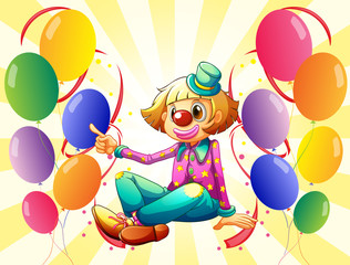 A female clown sitting surrounded with colorful balloons