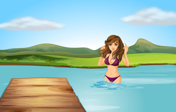 A girl at the beach with a wooden diving board