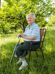 Old woman sitting on a chair