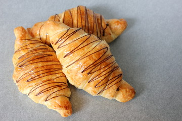 Chocolate croissant isolated on white paper