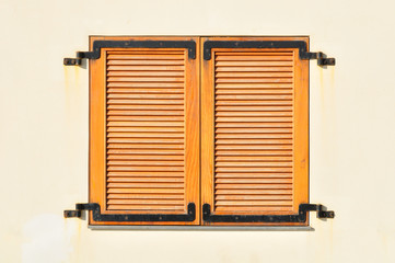 Window of a house in Tel Aviv closed with shutters.