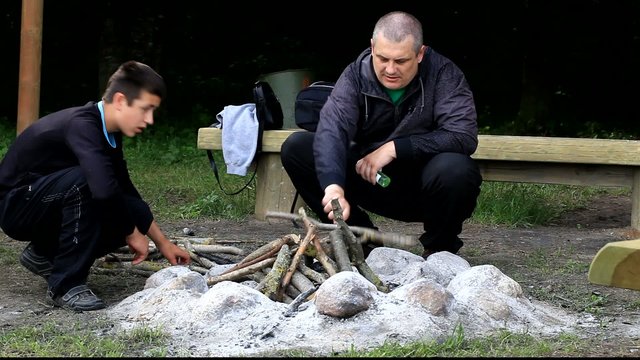 Father and son piling firewood for campfire episode 2