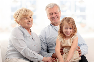 Fototapeta na wymiar Grandparents laughing with granddaughter