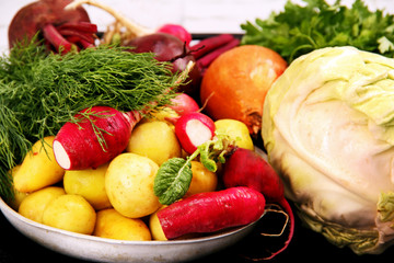 vegetables and herbs on a kitchen table.