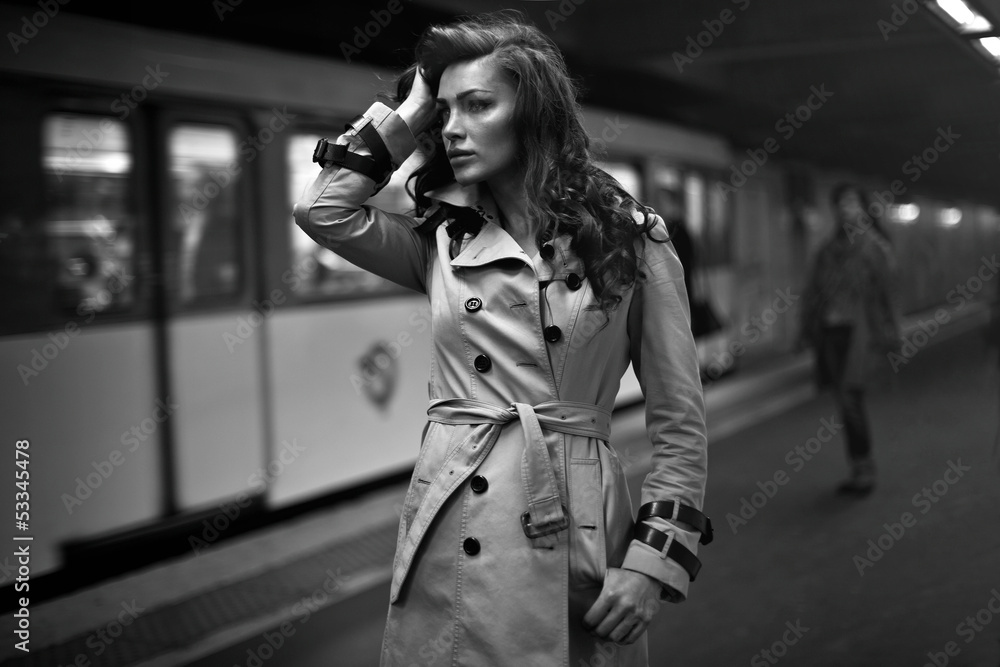 Wall mural Woman in coat waiting for someone