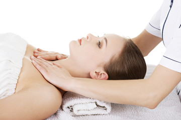 Fototapeta na wymiar Woman relaxing beeing massaged in spa saloon