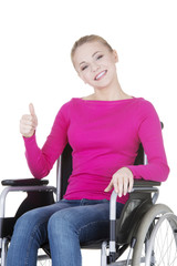 Attractive smiling disabled woman sitting in a wheel chair