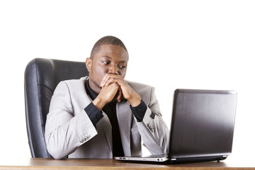 Stressed businessman working on laptop