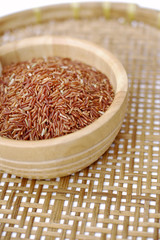 Red rice in wooden bowl