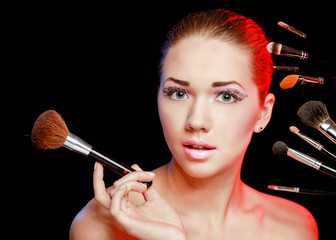 Beautiful young adult woman holds the make-up